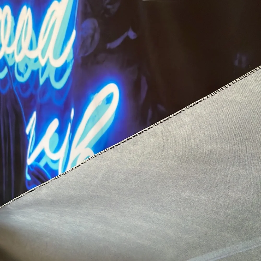 Black Tapestry with Blue Letters Graphic.